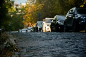 A flooded street lines with cars